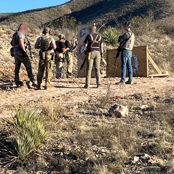 Veritus Shooting Group tactical instructor leading a group training session at desert range