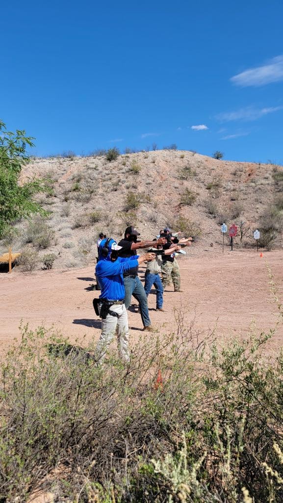 Veritus Shooting Group outdoor firearms training course with multiple students at desert range